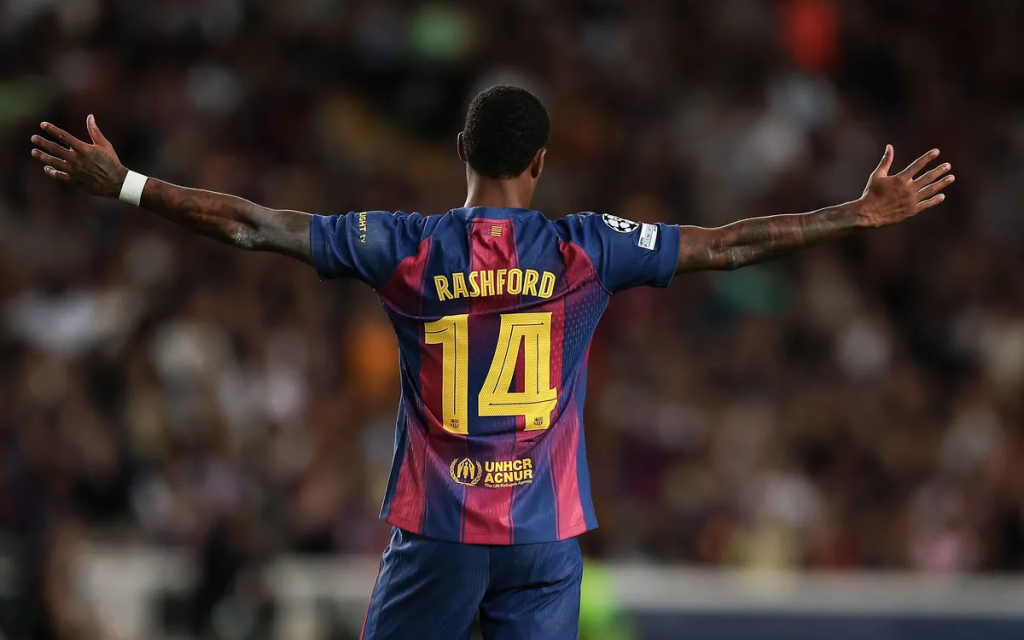 Backview of Rashford with his arms wide in a Barcelona shirt