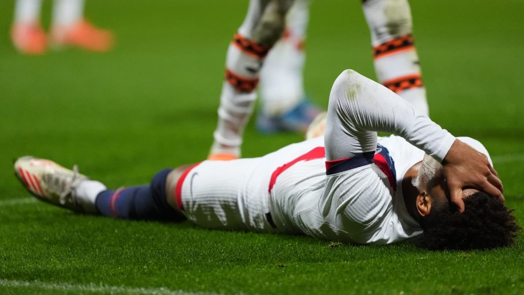 Desire Doue crying on the ground injured while playing for PSG against Lorient