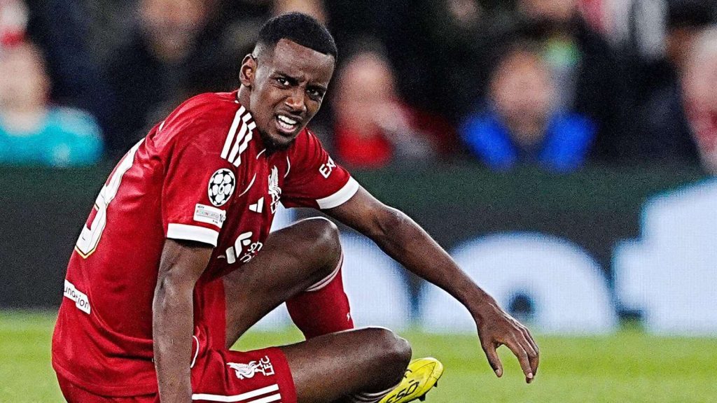 Alexander Isak sitting on the pitch for Liverpool, injured