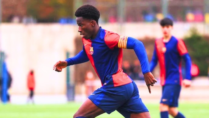 Ebrima Tunkara running with the ball in a barca shirt