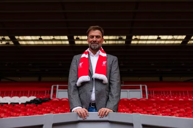 Klopp in the Anfield stands with a Liverpool scarf on