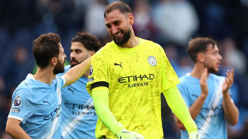 Gianluigi Donnarumma smiling with his Manchester City teammates