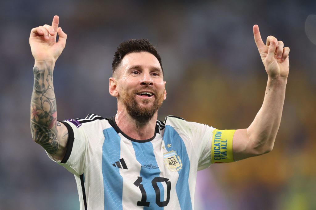 Lionel Messi pointing to the sky in an Argentina shirt