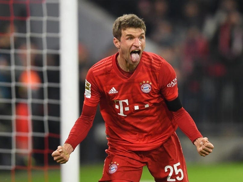 Thomas Muller celebrating with his tongue out in a Bayern Munich shirt