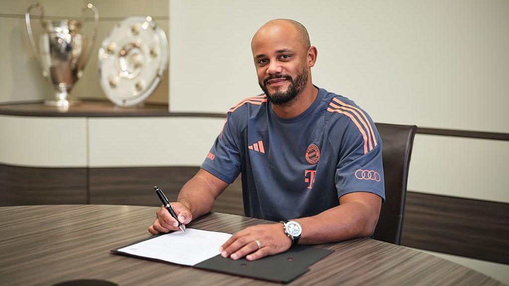 Vincent Kompany signing a contract for Bayern Munich