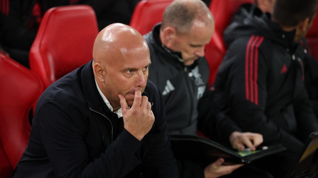 Arne Slot sitting on the Liverpool bench and thinking