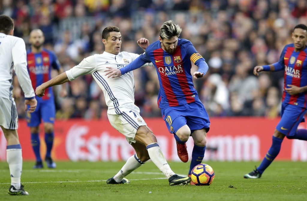 Cristiano Ronaldo tackling Lionel MessiCristiano Ronaldo tackling Lionel Messi