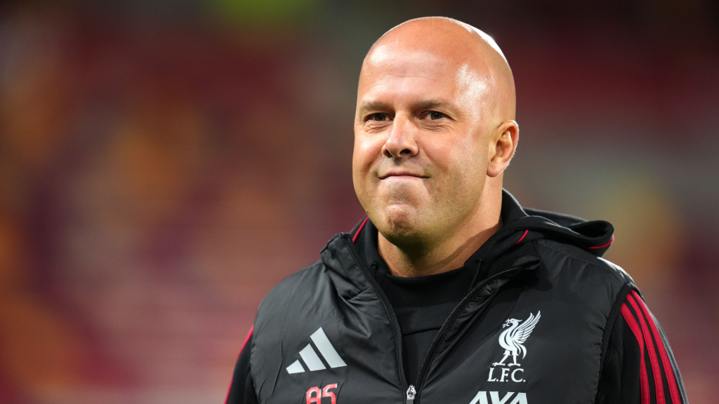 Frontview of Arne Slot sucking in his lips while managing Liverpool