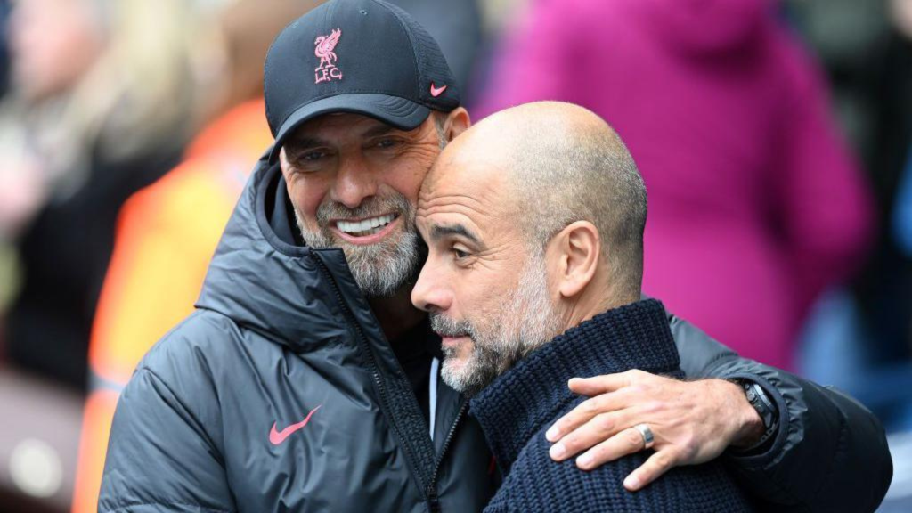 Jurgen Klopp and Pep Guardiola hugging and smiling