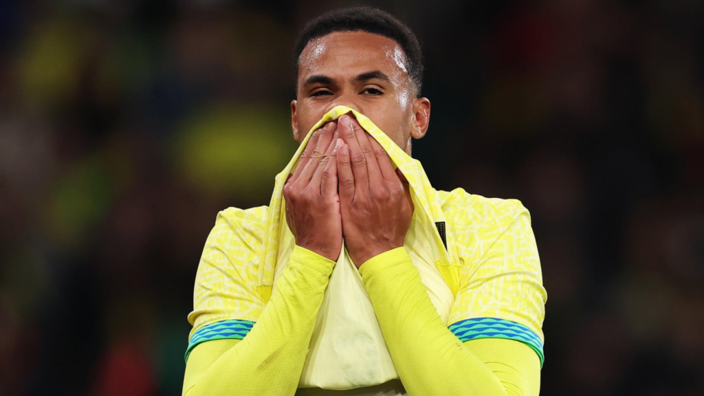 Frontview of Gabriel hiding his face behind his shirt while playing for Brazil