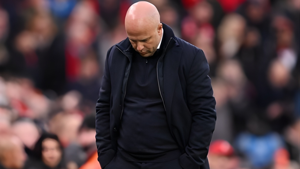 Frontview of Arne Slot with his head down as Liverpool manager