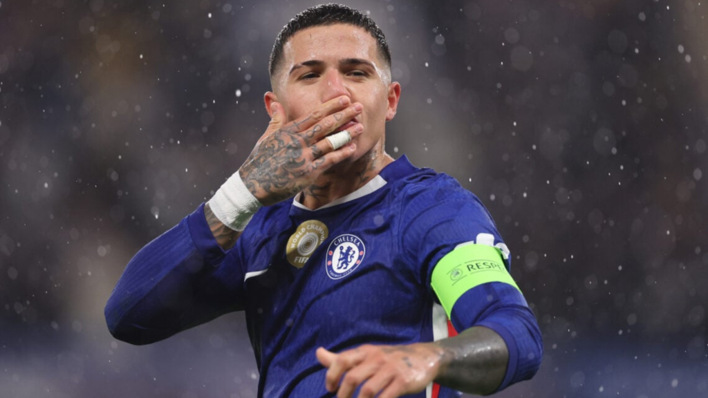 Enzo Fernandez kissing his hand on a rainy night while playing for Chelsea
