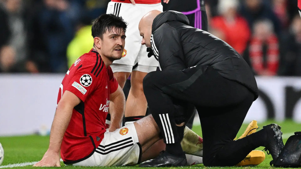 Harry Maguire sitting on the pitch for Manchester United, injured