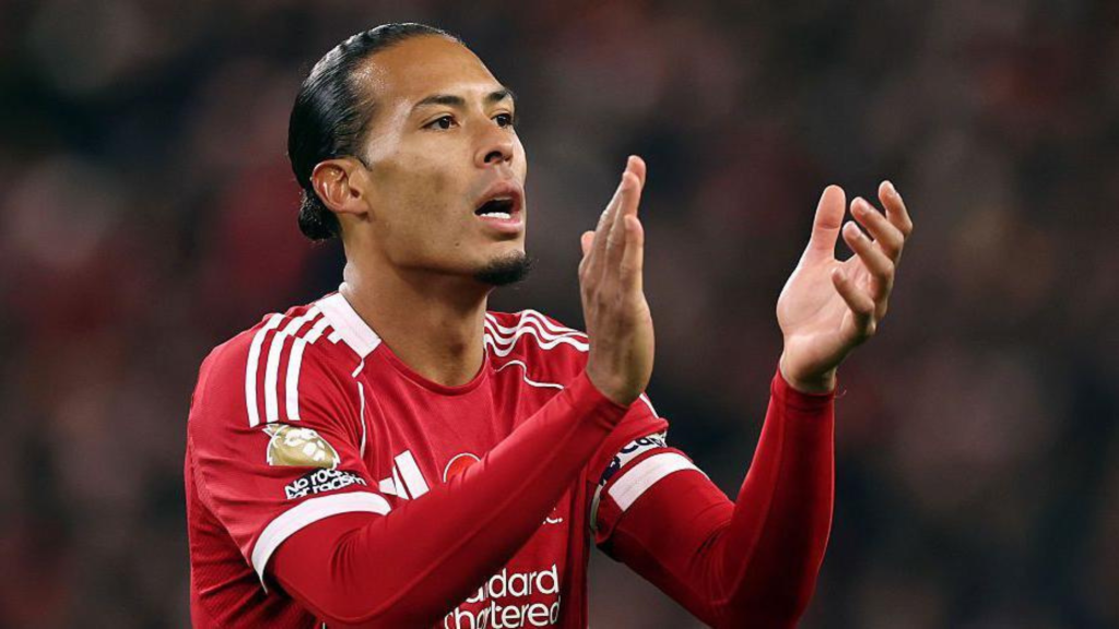 Sideview of Virgil van Dijk clapping while playing for Liverpool
