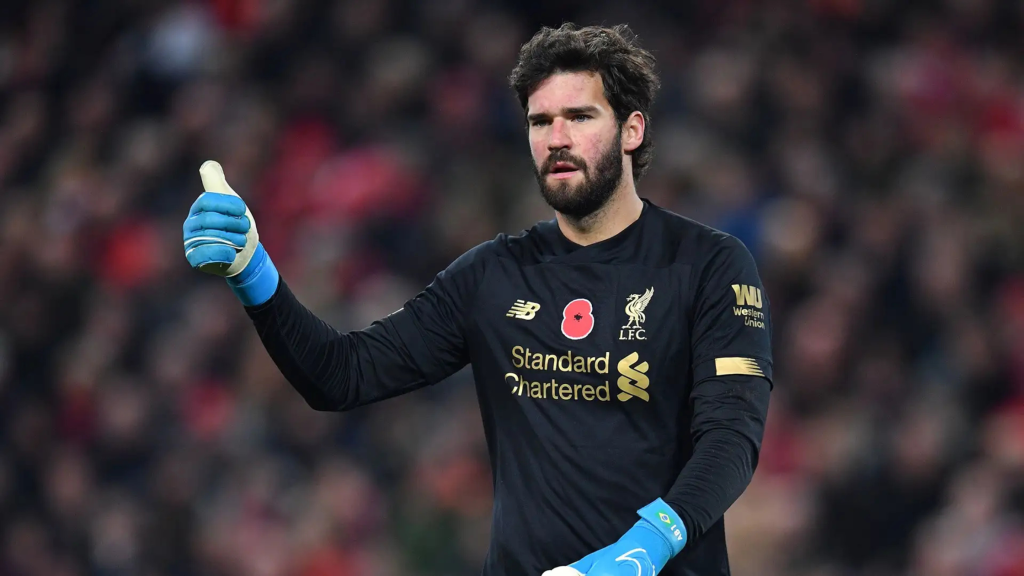 Alisson Becker throwing a thumbs up while playing for Liverpool