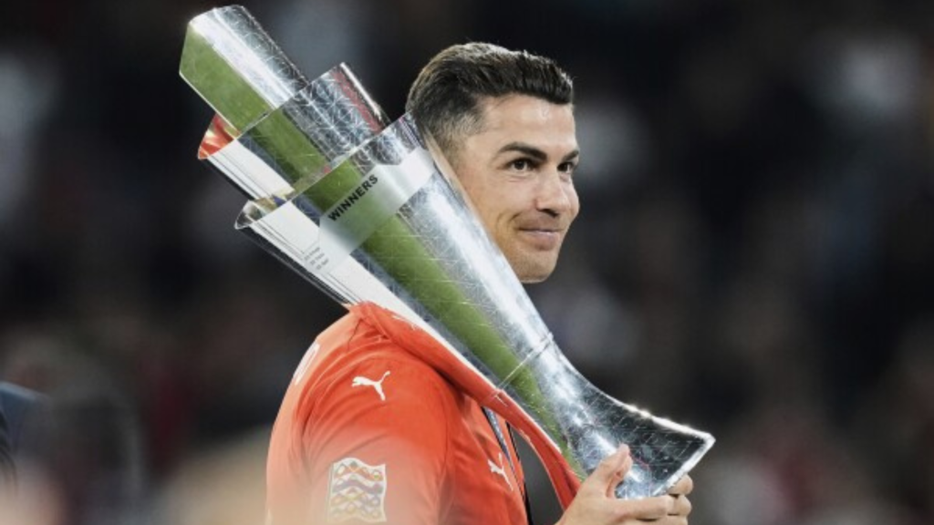 Cristiano Ronaldo holding the Nations League trophy over his shoulder