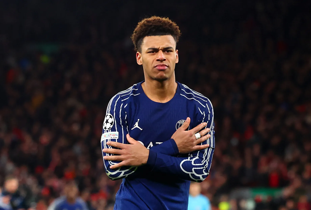 Frontview of Desire Doue doing the cold celebration in a PSG shirt