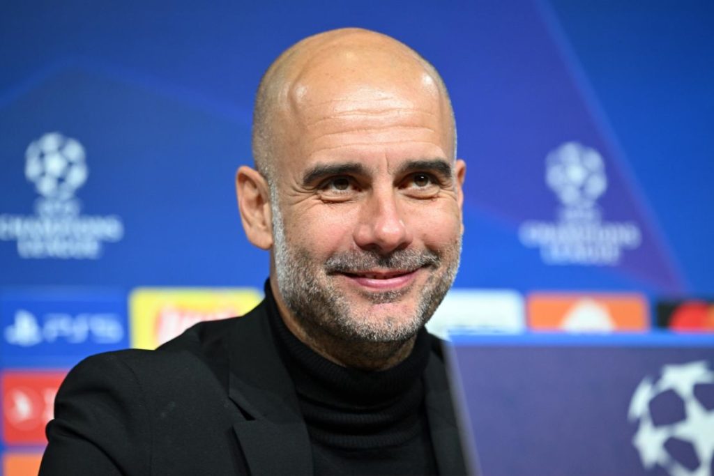 Frontview of Pep Guardiola smiling as Manchester City coach