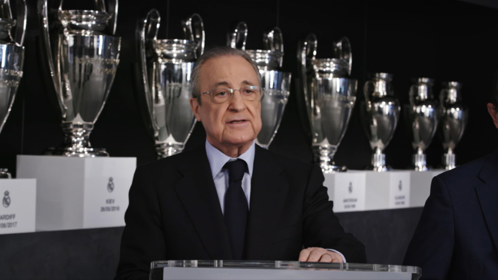 Flortentino Perez speaking infront of the Champions League titles of Real Madrid