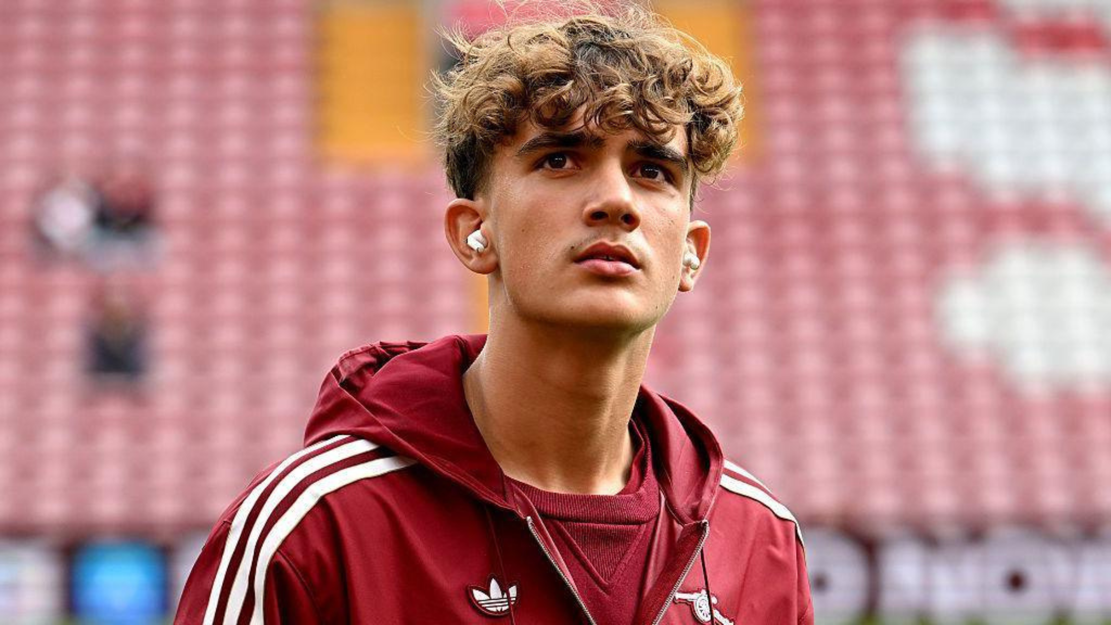 Frontview of Max Dowman in an Arsenal hoodie with headphones