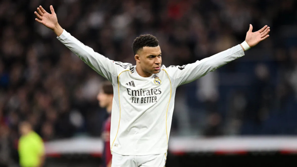 Mbappe arms up and wide celebrating as Real Madrid player